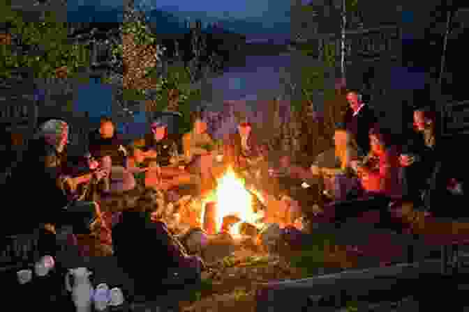 A Group Of People Gathered Around A Campfire, Their Faces Illuminated By The Warm Glow. Crossroads And Other Tales Of Valdemar (Tales Of Valdemar 3)
