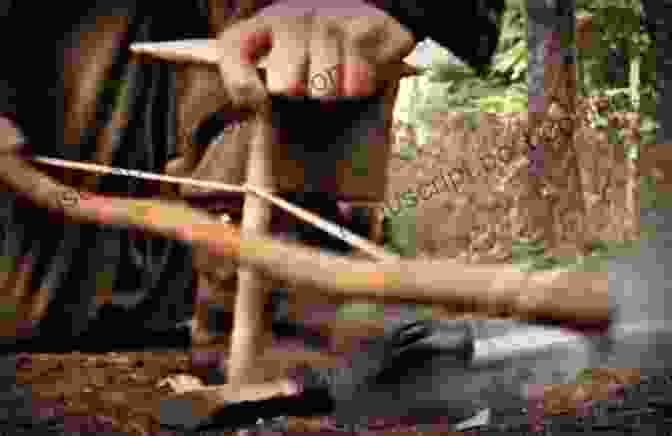 A Man Using Sticks To Build A Campfire, Highlighting The Practical Uses Of Sticks. The Stick Book: Loads Of Things You Can Make Or Do With A Stick (Going Wild)